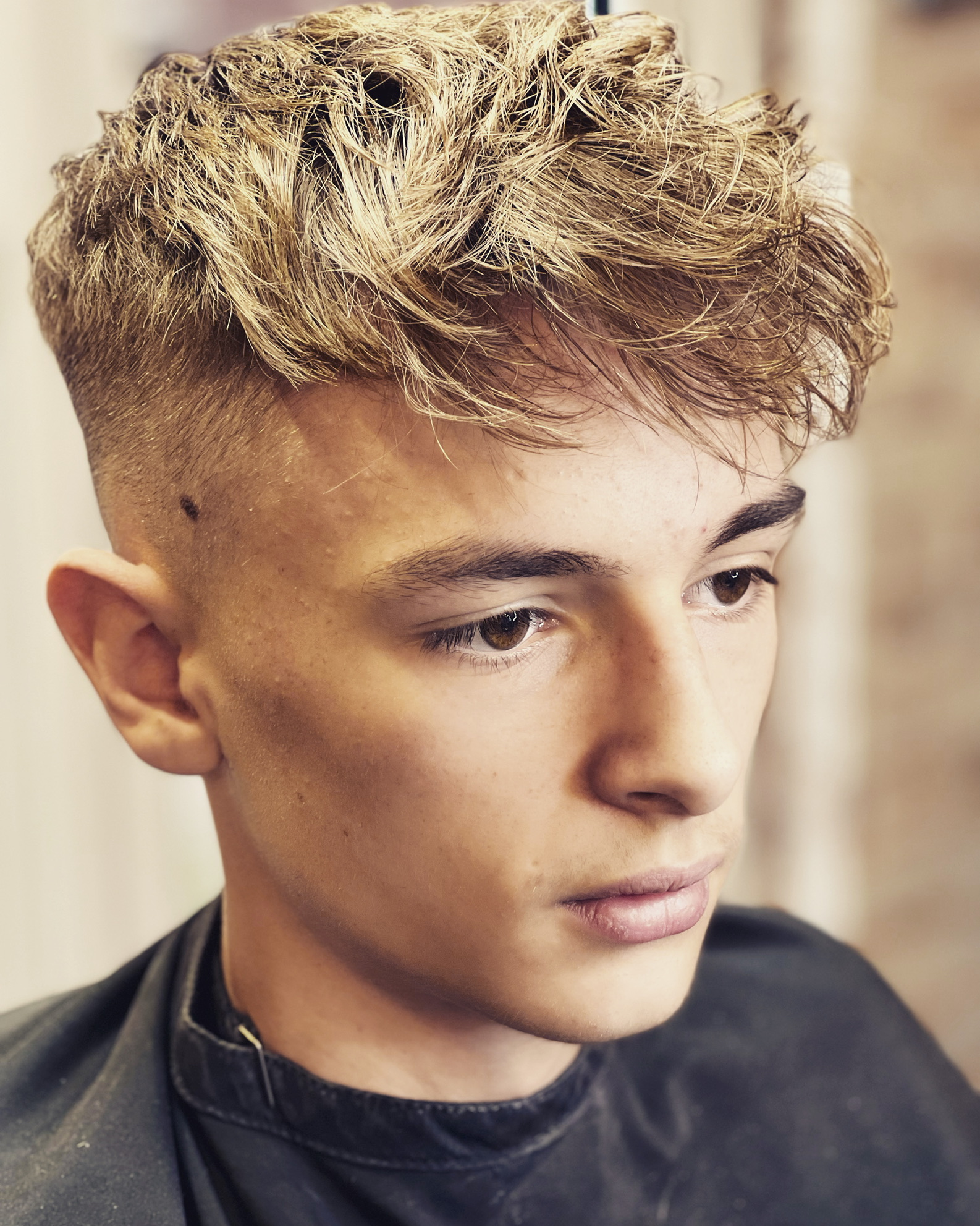 A textured crop with a skin fade, seen from the front